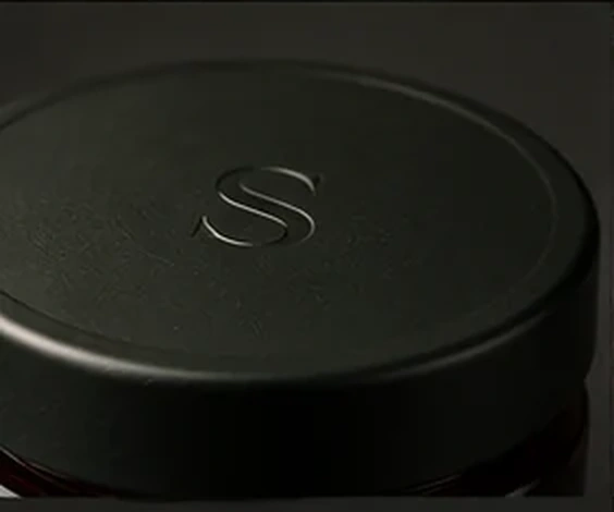 Close-up packaging concept of the forest-black SELVEH lid